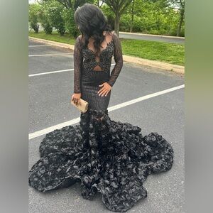 Beautiful black prom dress with beaded details and adorned with flowers.